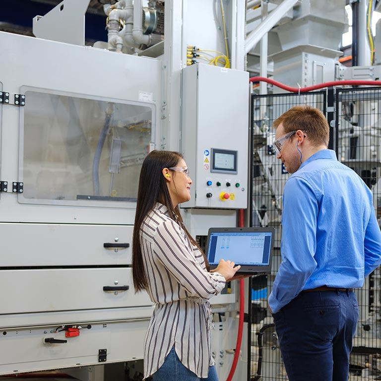 Team member talking near a production line