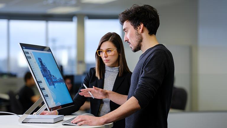 team members looking at a computer