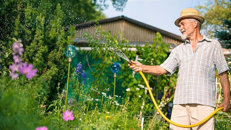 a man watering his garden