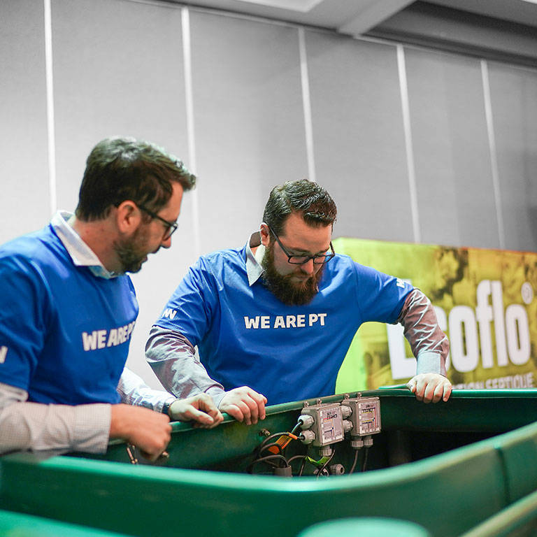 Two team members looking inside an Ecoflo biofilter