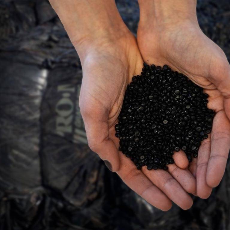 Hands holding PCR pellets from our plant mega bales