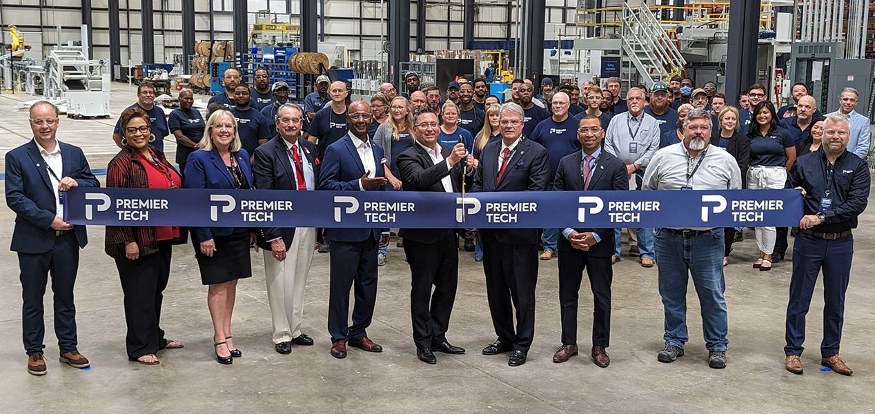 Premier Tech team members and Montgomery representatives cutting a ribbon.