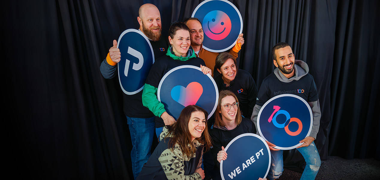 Team members smiling in a photobooth