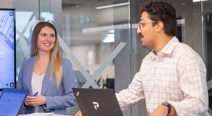 People smiling during a meeting at Premier Tech