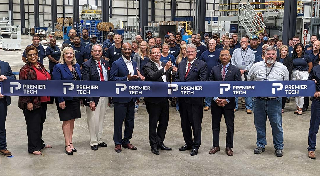 Premier Tech team members and Montgomery representatives cutting a ribbon.