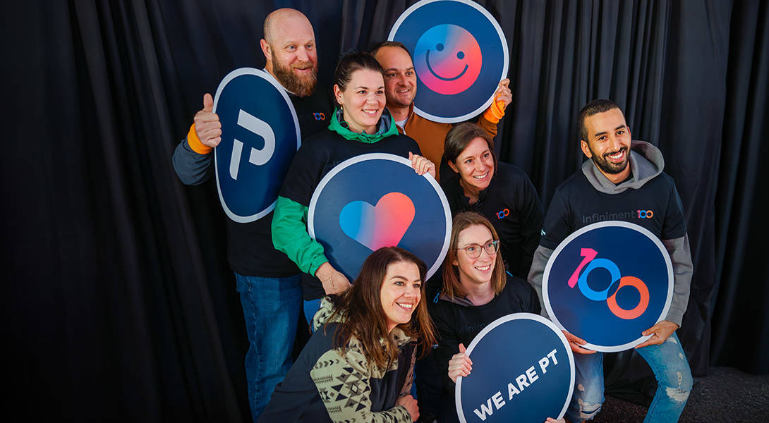 Team members smiling in a photobooth