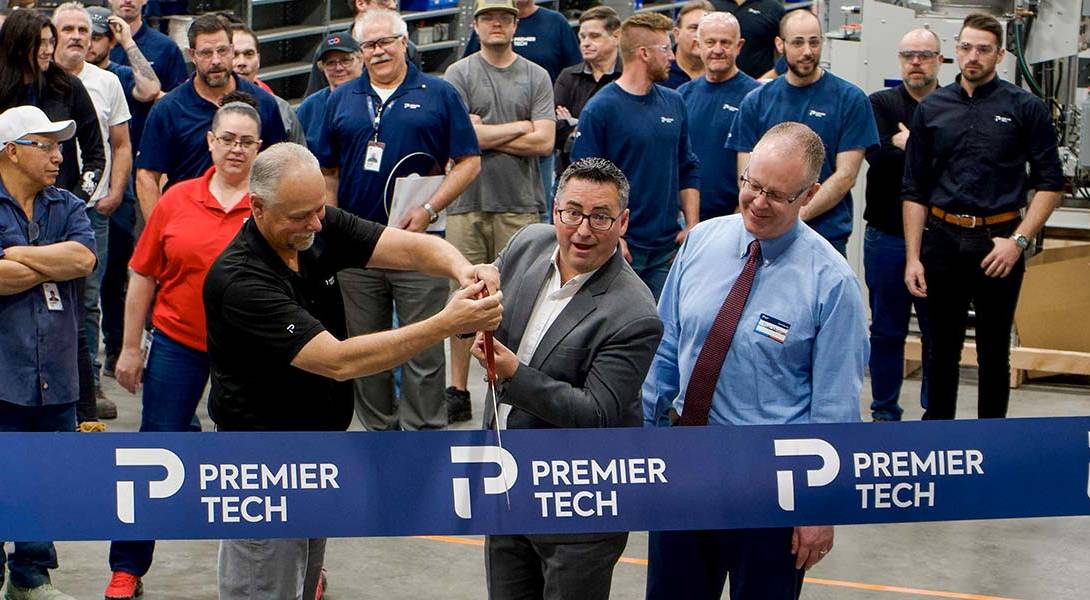 Premier Tech team members and Ryan Westergard, mayor of Wood Cross City cutting a ribbon.