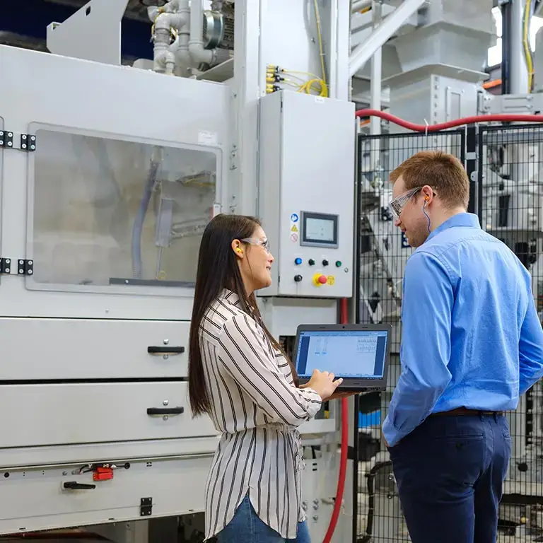 Team member talking near a production line