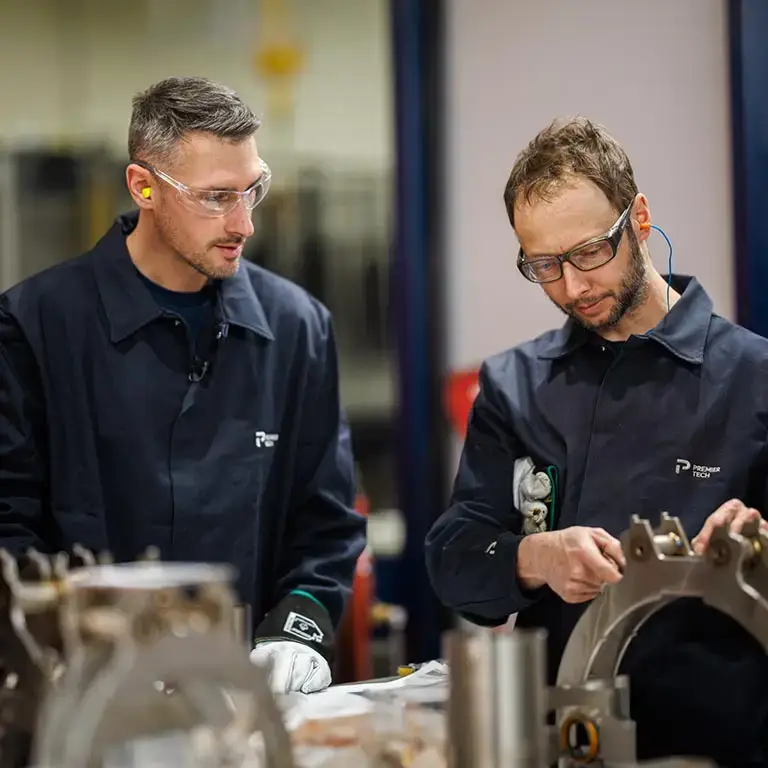 Two team members working in a plant
