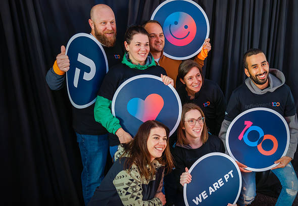 Team members smiling in a photobooth