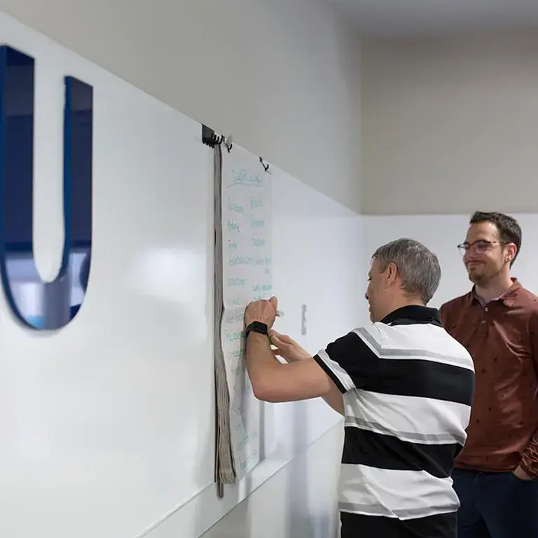 Two team members working together