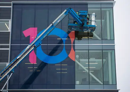 Logo being install on a building