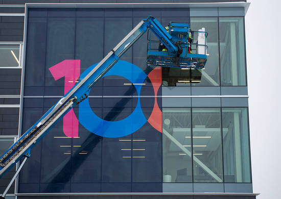 Logo being install on a building